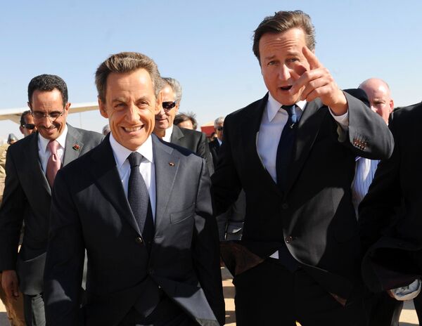 Then British Prime Minister David Cameron (R) gestures next to then French President Nicholas Sarkozy as they arrive at Benghazi airport on September 15, 2011. Then British Prime Minister David Cameron (R) gestures next to then French President Nicholas Sarkozy as they arrive at Benghazi airport on September 15, 2011. - Sputnik International