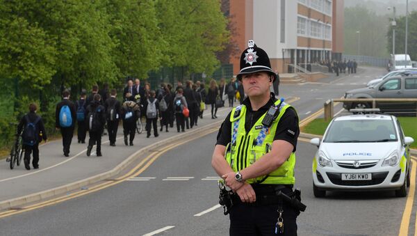 A police officer stands at Corpus Christi Catholic College in Leeds, northern England on April 29, 2014 - Sputnik International