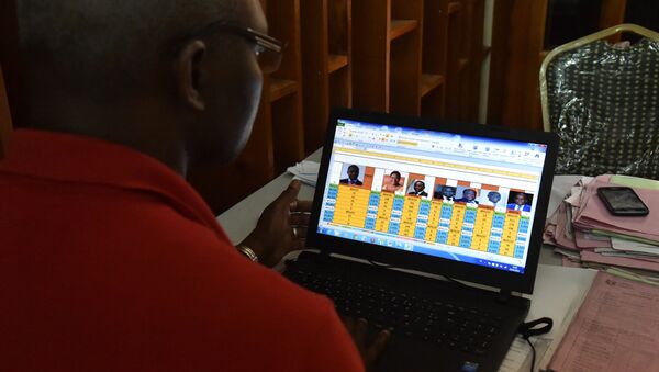 A technician checks the results of the presidential election at the local campaign headquarters of Ivory Coast's Rally of the Houphouetists for Democracy and Peace (RHDP) party in Gagnoa on October 26, 2015, a day after the presidential election - Sputnik International