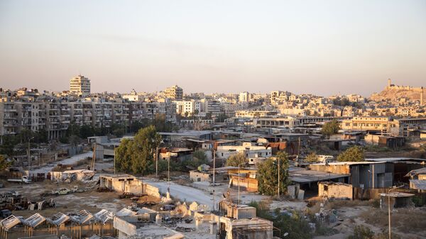 A picture taken on July 29, 2016 shows a general view of Karaj al-Hajz corridor (C) in the rebel-held part of Aleppo, leading towards the government controlled area of the Masharqa neighbourhood (background) A picture taken on July 29, 2016 shows a general view of Karaj al-Hajz corridor (C) in the rebel-held part of Aleppo, leading towards the government controlled area of the Masharqa neighbourhood (background) - Sputnik International