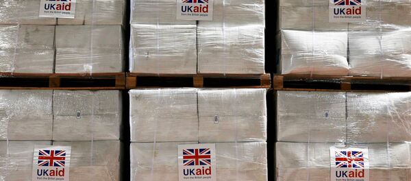 Boxes containing kitchen sets are stored at a UK Aid Disaster Response Centre where humanitarian supplies are being collected to be airlifted to Iraq at Cotswold Airport near the village of Kemble, Gloucestershire, southern England on August 14, 2014. - Sputnik International
