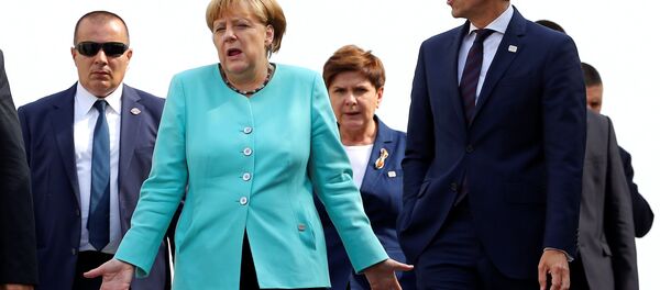 Germany's Chancellor Angela Merkel (L) and Austria's Chancellor Christian Kern arrive to pose for a family photo during the European Union summit - the first one since Britain voted to quit - in Bratislava, Slovakia, September 16, 2016. Germany's Chancellor Angela Merkel (L) and Austria's Chancellor Christian Kern arrive to pose for a family photo during the European Union summit - the first one since Britain voted to quit - in Bratislava, Slovakia, September 16, 2016. - Sputnik International