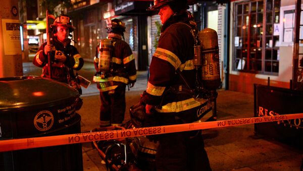 New York City firefighters stand near the site of an explosion in the Chelsea neighborhood of Manhattan, New York, U.S. September 18, 2016. - Sputnik International