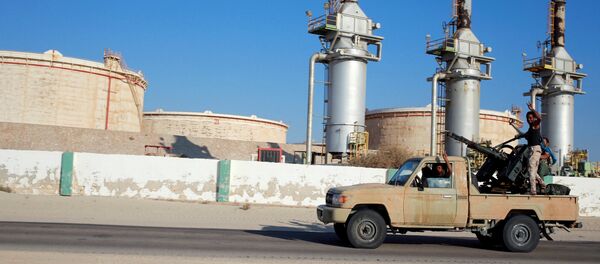 Libyan forces loyal to eastern commander Khalifa Haftar ride a pickup truck at the Zueitina oil terminal in Zueitina, west of Benghazi, Libya. file photo  - Sputnik International