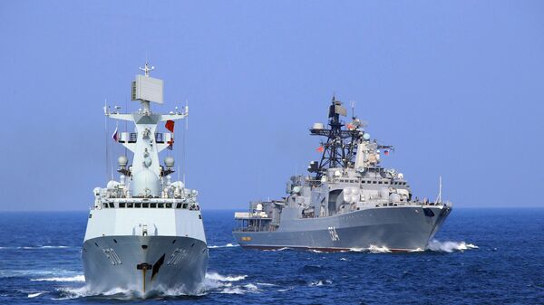 In this Friday, Sept. 16, 2016 photo released by Xinhua News Agency, Chinese Navy frigate Huangshan, left, and Russian Navy antisubmarine ship Admiral Tributs take part in a joint naval drill at sea off south China's Guangdong Province. - Sputnik International