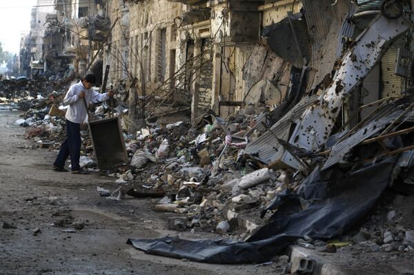 A Syrian child clears debris from a street in the northeastern city of Deir Ezzor A Syrian child clears debris from a street in the northeastern city of Deir Ezzor - Sputnik International