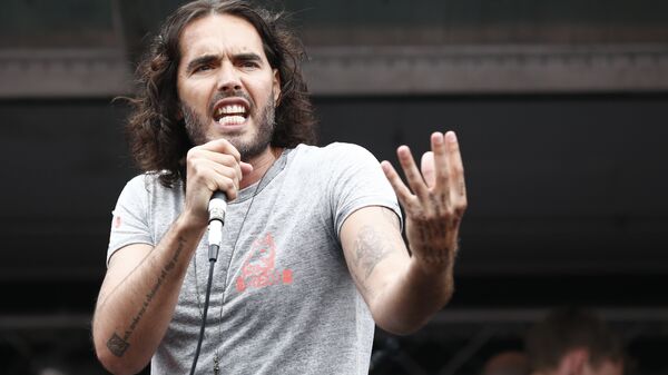 British comedian Russell Brand speaks to protesters following a march against the British government's spending cuts and austerity measures in London on June 20, 2015. - Sputnik International