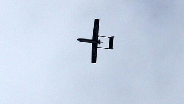 A drone belonging to the Ezzedine al-Qassam Brigades, Hamas' armed wing, flies over Gaza City on December 14, 2014 during a parade by Palestinian militants marking the 27th anniversary of the Islamist movement’s creation. - Sputnik International