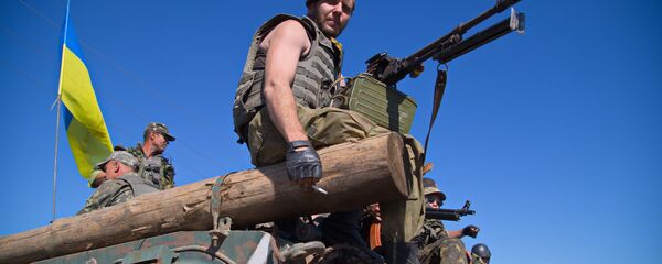 Ukrainian servicemen sit on an Armoured Personal Carrier (APC) as the column of Ukrainian forces passes near Artemivsk in the Donetsk region on June 9, 2015 Ukrainian servicemen sit on an Armoured Personal Carrier (APC) as the column of Ukrainian forces passes near Artemivsk in the Donetsk region on June 9, 2015 - Sputnik International