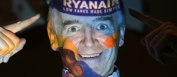 Chief Executive Officer of Irish airline Ryanair Michael O'Leary poses with his company's logo projected on his face as he attends a press conference at a hotel in London on August 31, 2016. Chief Executive Officer of Irish airline Ryanair Michael O'Leary poses with his company's logo projected on his face as he attends a press conference at a hotel in London on August 31, 2016. - Sputnik International