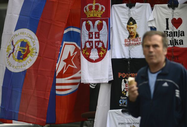 In this photo taken on Wednesday, Sept. 21, 2016. Bosnian man passes by flags of Bosnia's Serb mini state Republic of Srpska and t-shirt with photos of Russian President Vladimir Putin in the Bosnian town of Banja Luka, 240 kms (150 miles) northwest of the Bosnian capital of Sarajevo In this photo taken on Wednesday, Sept. 21, 2016. Bosnian man passes by flags of Bosnia's Serb mini state Republic of Srpska and t-shirt with photos of Russian President Vladimir Putin in the Bosnian town of Banja Luka, 240 kms (150 miles) northwest of the Bosnian capital of Sarajevo - Sputnik International