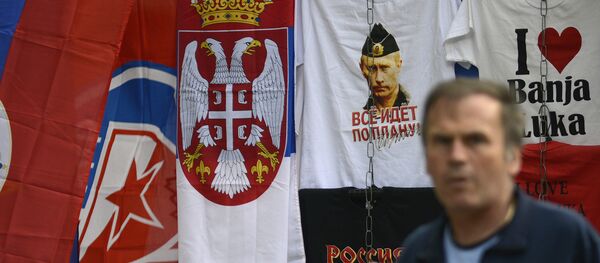In this photo taken on Wednesday, Sept. 21, 2016. Bosnian man passes by flags of Bosnia's Serb mini state Republic of Srpska and t-shirt with photos of Russian President Vladimir Putin in the Bosnian town of Banja Luka, 240 kms (150 miles) northwest of the Bosnian capital of Sarajevo In this photo taken on Wednesday, Sept. 21, 2016. Bosnian man passes by flags of Bosnia's Serb mini state Republic of Srpska and t-shirt with photos of Russian President Vladimir Putin in the Bosnian town of Banja Luka, 240 kms (150 miles) northwest of the Bosnian capital of Sarajevo - Sputnik International