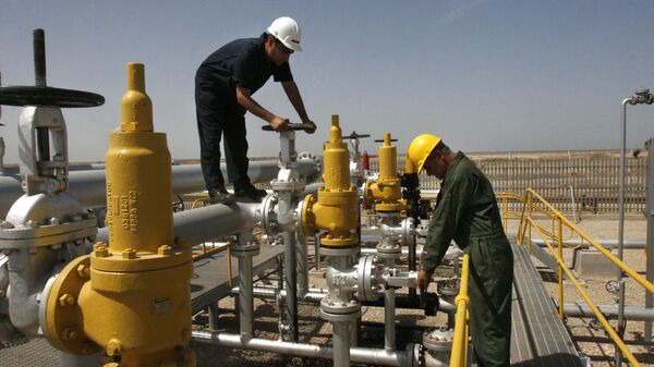 Iranian oil technician, right, and coworker  work at the oil separator facilities in Azadegan oil field, some 480 miles (800 kilometers) southwest of the capital, Tehran, Iran - Sputnik International