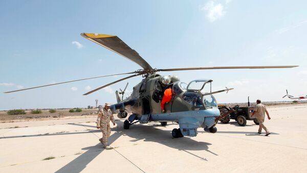 Members of Libyan forces allied with the UN-backed government prepare a renovated Libyan helicopter at Misurata air base, Libya September 4, 2016 - Sputnik International
