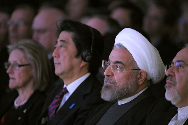 Iranian President Hassan Rouhani (R) sits next to Japanese Prime Minister Shinzo Abe (L) during the opening session of the World Economic Forum in Davos on January 22, 2014 Iranian President Hassan Rouhani (R) sits next to Japanese Prime Minister Shinzo Abe (L) during the opening session of the World Economic Forum in Davos on January 22, 2014 - Sputnik International