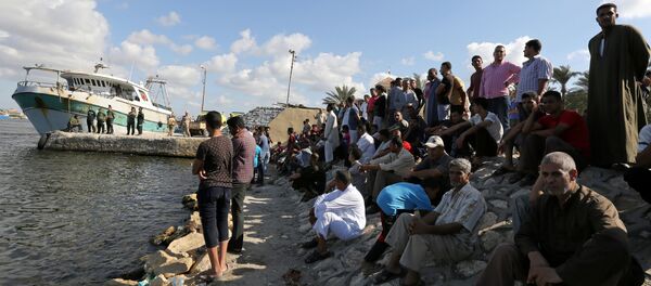 People gather along the shore of the Mediterranean Sea during a search for victims after a migrant boat capsized, in Al-Beheira, Egypt, September 22, 2016 People gather along the shore of the Mediterranean Sea during a search for victims after a migrant boat capsized, in Al-Beheira, Egypt, September 22, 2016 - Sputnik International