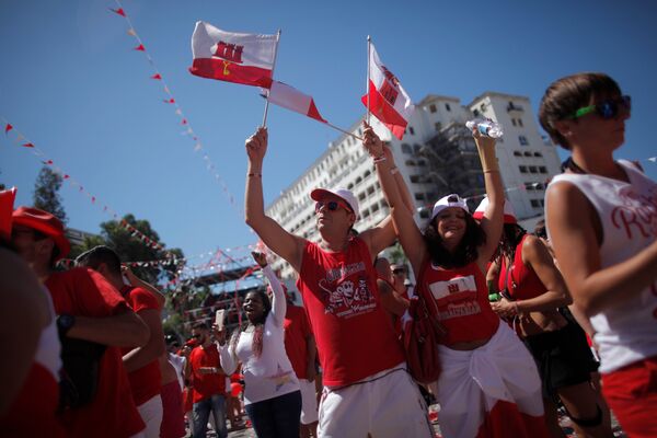People wave Gibraltarian flags at Casemates square during the Gibraltar National Day celebrations, in the British overseas territory of Gibraltar, historically claimed by Spain, September 10, 2016.  - Sputnik International