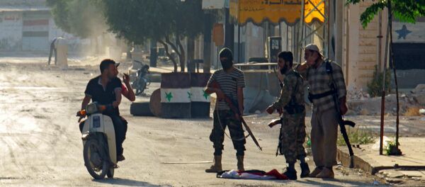 Terrorists from the Jund al-Aqsa group man a checkpoint in Taybat al Imam town after they advanced in the town in Hama province, Syria August 31, 2016 - Sputnik International