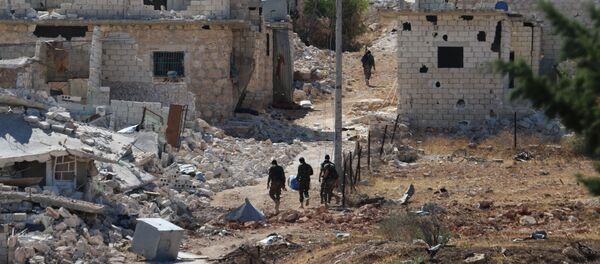Syrian government forces walk amidst debris in the largely deserted Palestinian refugee camp of Handarat, north of Aleppo, on September 24, 2016 - Sputnik International