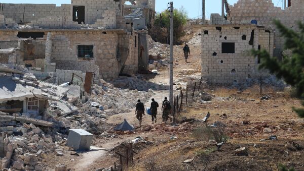 Syrian government forces walk amidst debris in the largely deserted Palestinian refugee camp of Handarat, north of Aleppo, on September 24, 2016 - Sputnik International