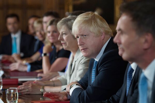 British Foreign Secretary Boris Johnson (2R) sits next to British Prime Minister Theresa May (3R) during a meeting of the cabinet at the Prime Minister's country retreat Chequers near the village of Ellesborough in Buckinghamshire, northwest of London, on August 31, 2016.  - Sputnik International