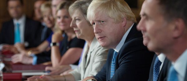 British Foreign Secretary Boris Johnson (2R) sits next to British Prime Minister Theresa May (3R) during a meeting of the cabinet at the Prime Minister's country retreat Chequers near the village of Ellesborough in Buckinghamshire, northwest of London, on August 31, 2016. - Sputnik International