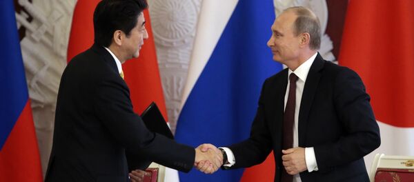 Japanese Prime Minister Shinzo Abe (L) shakes hands with Russian President Vladimir Putin Japanese Prime Minister Shinzo Abe (L) shakes hands with Russian President Vladimir Putin - Sputnik International