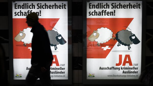 A man walks past backlit posters of the right-wing populist Swiss People's Party (SVP) that translate from German as Finally Create Security to advertise their initiative for the eviction of criminal foreigners in Zurich on February 25, 2016. - Sputnik International
