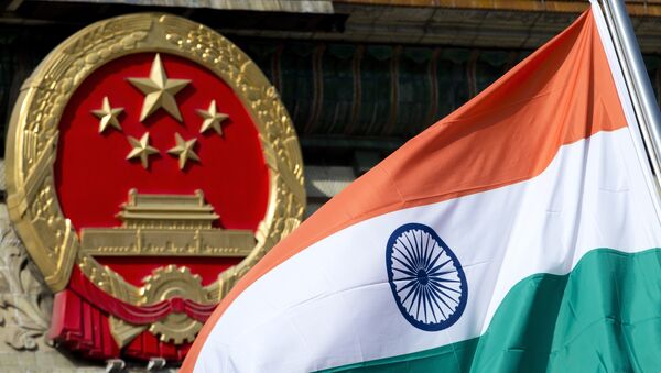 An Indian national flag is flown next to the Chinese national emblem. (File) - Sputnik International