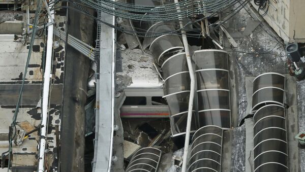 A derailed New Jersey Transit train is seen under a collapsed roof after it derailed and crashed into the station in Hoboken, New Jersey, U.S. September 29, 2016 - Sputnik International