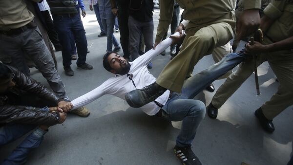 Indian policemen try to detain a supporter of Jammu and Kashmir state lawmaker, Engineer Abdul Rashid Sheikh, during a protest in Srinagar, Indian controlled Kashmir, Monday, Sept. 26, 2016 - Sputnik International