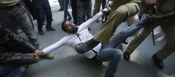 Indian policemen try to detain a supporter of Jammu and Kashmir state lawmaker, Engineer Abdul Rashid Sheikh, during a protest in Srinagar, Indian controlled Kashmir, Monday, Sept. 26, 2016 - Sputnik International