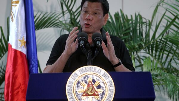 Philippines President Rodrigo Duterte gestures during a news conference upon his arrival from a state visit in Vietnam at the International Airport in Davao city, Philippines September 30, 2016. - Sputnik International