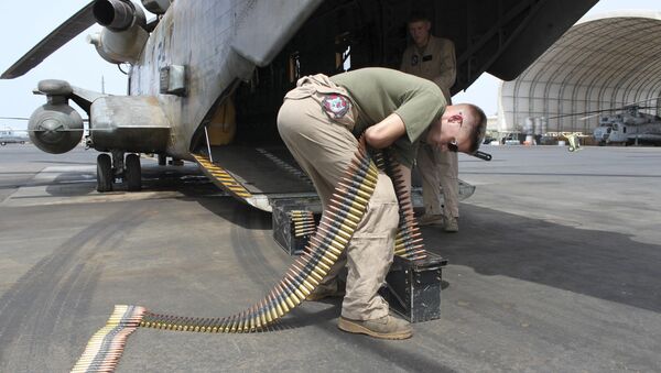 In this photo taken May 26, 2010, Sgt. Tyler Johnson, 23, of Portland, Ore., loads ammunition cans for a .50 caliber machine gun mounted on the back of a Marine CH53 at Camp Lemonnier, Djibouti, the only U.S. base in Africa - Sputnik International