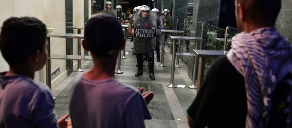 Refugee children chant in front of riot police during a prostest of refugees living in squats and solidarity groups over a detention by police of five migrant children earlier this week in central Athens on September 30, 2016 Refugee children chant in front of riot police during a prostest of refugees living in squats and solidarity groups over a detention by police of five migrant children earlier this week in central Athens on September 30, 2016 - Sputnik International