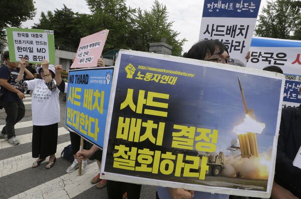 Protesters stage a rally to denounce deploying the Terminal High-Altitude Area Defense (THAAD) in front of the Defense Ministry in Seoul, South Korea, Wednesday, July 13, 2016 Protesters stage a rally to denounce deploying the Terminal High-Altitude Area Defense (THAAD) in front of the Defense Ministry in Seoul, South Korea, Wednesday, July 13, 2016 - Sputnik International