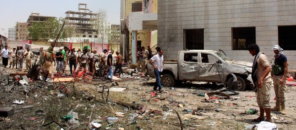 Fighters loyal to the government gather at the site of a suicide car bombing in Yemen’s southern city of Aden, Yemen, Monday, Aug. 29, 2016 - Sputnik International