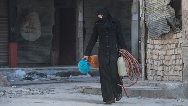 A woman walks in a residential area of Aleppo, a city divided by a front line (File) - Sputnik International