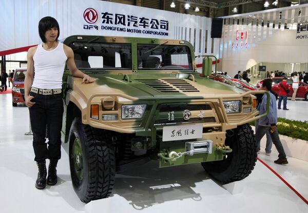 FILE - In this April 20, 2009 file photo, a model poses next to Dongfeng Motor's Mengshi, or Brave Soldier, at the Shanghai International Auto Show in Shanghai, China - Sputnik International