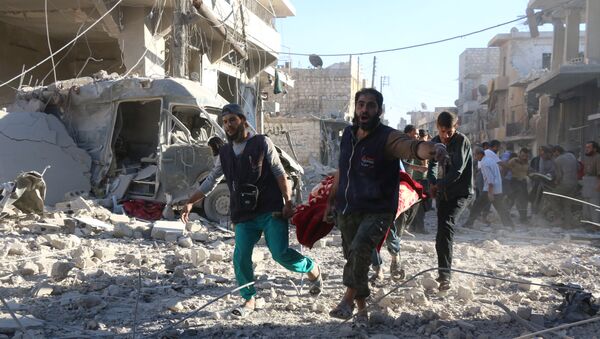 Syrian volunteers carry an injured person on a stretcher following Syrian government forces airstrikes on the rebel held neighbourhood of Heluk in Aleppo, on September 30, 2016 - Sputnik International