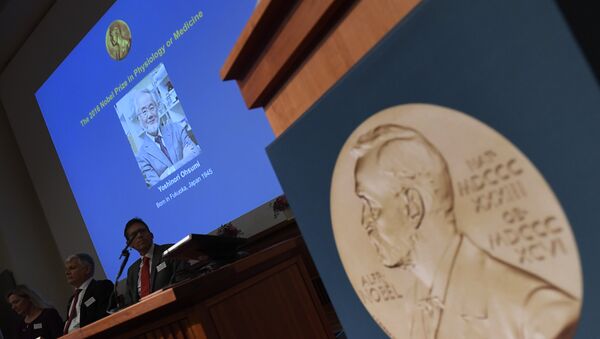 A portrait of the 2016 Nobel Medicine Prize winner Yoshinori Ohsumi of Japan is displayed behind members of the Nobel Committtee for Physiology or Medicine 2016 during a press conference to announce the winner of the 2016 Nobel Prize in Medicine at the Nobel Forum in Stockholm on October 3, 2016. - Sputnik International