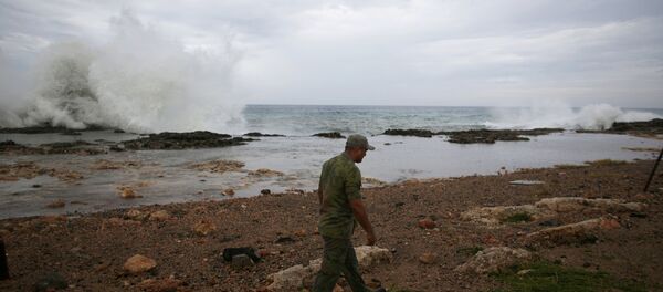 An army officer checks the beach in Siboney ahead of the arrival of Hurricane Matthew, Cuba, October 4, 2016. - Sputnik International