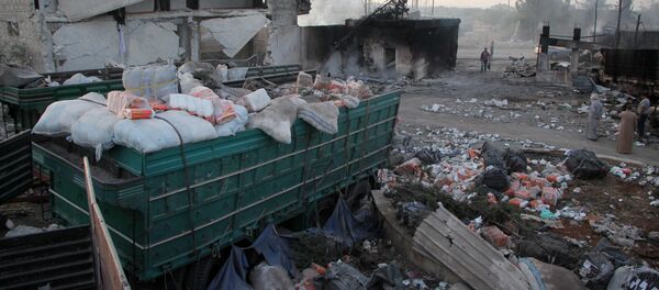aid strewn across the floor in the town of Orum al-Kubra on the western outskirts of the northern Syrian city of Aleppo, the morning after a convoy delivering aid was hit by a deadly air strike. - Sputnik International