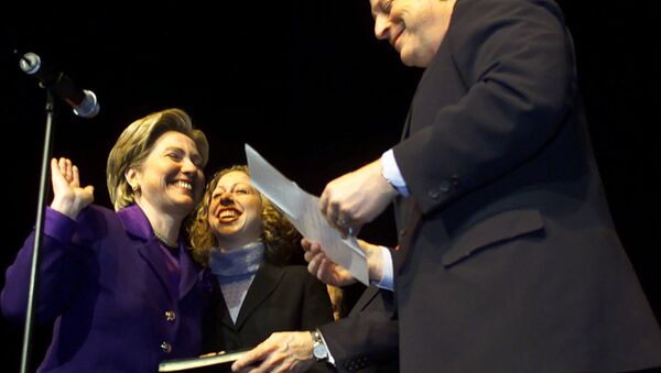 Sen. Hillary Rodham Clinton laughs with her daughter Chelsea during a mock swearing-in with Vice President Al Gore at the New York State Democratic Committee Tribute to Senator Clinton, celebrating her U.S. Senate seat Sunday, Jan. 7, 2001, at Madison Square Garden, in New York City. - Sputnik International