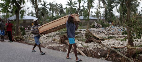 Men carry a coffin after Hurricane Matthew hit Cavaillon, Haiti, October 6, 2016 Men carry a coffin after Hurricane Matthew hit Cavaillon, Haiti, October 6, 2016 - Sputnik International