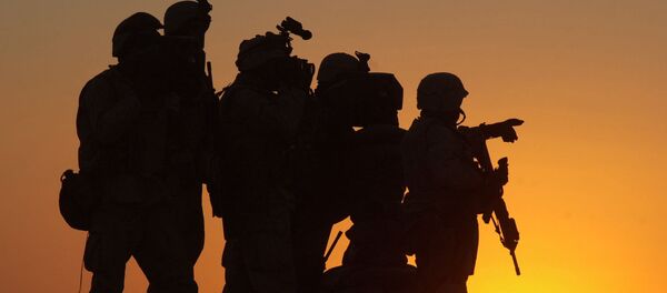 U.S. Marines scan the northwest perimeter of the American military compound at Afghanistan's Kandahar airport using sophisticated thermal imagery equipment, while Marines in light armored vehicles, supported by U.S. special forces and helicopters, search houses outside the perimeter of the airfield, Monday Jan. 14, 2002 - Sputnik International