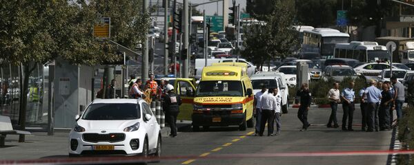 Israeli security forces cordon off the site of a shooting attack near Israeli police headquarters, close to the line dividing mainly Palestinian east Jerusalem from the mostly Jewish western sector of the city, on October 9, 2016 - Sputnik International