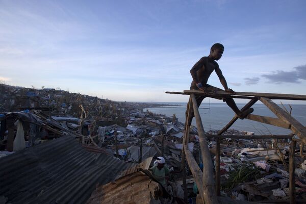 A resident works to repair his roof after it was ripped away by Hurricane Matthew in Jeremie, Haiti, Friday, Oct. 7, 2016 A resident works to repair his roof after it was ripped away by Hurricane Matthew in Jeremie, Haiti, Friday, Oct. 7, 2016 - Sputnik International