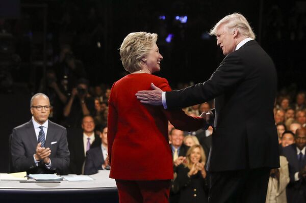 In this September 26, 2016 file photo, Democratic presidential nominee Hillary Clinton and Republican presidential nominee Donald Trump shake hands during the presidential debate at Hofstra University in Hempstead, New York. - Sputnik International