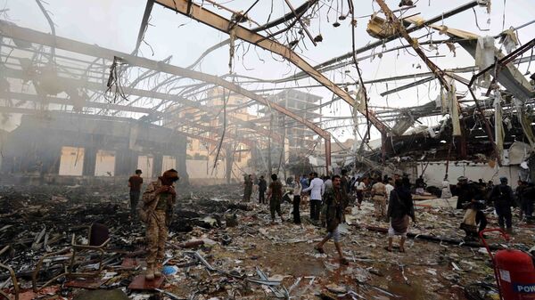 People inspect the aftermath of a Saudi-led coalition airstrike in Sanaa, Yemen, Saturday, Oct. 8, 2016 - Sputnik International
